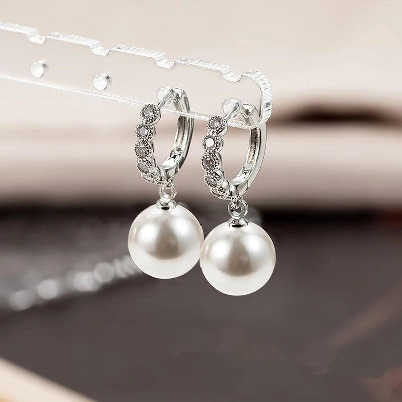 Silver-tone hoop earrings with zirconia clusters and two pearl drop charms