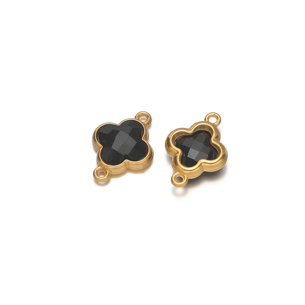 Four-leaf clover glass charm pendant with dark gray-black gem and gold-tone loop