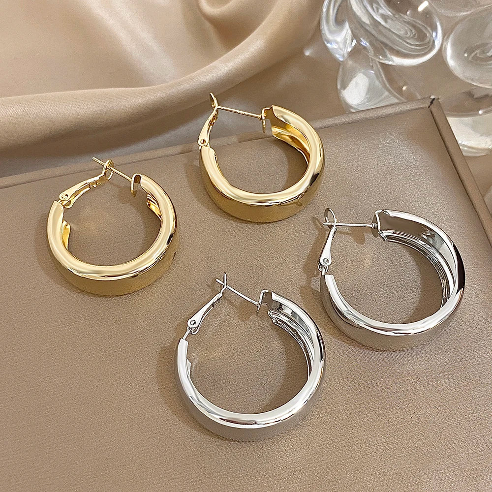 Gold- and silver-tone chunky hoop earrings with hinged clasps
