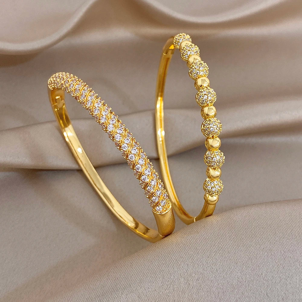 Gold plated copper cuff bangles with zircon accents and ball beads