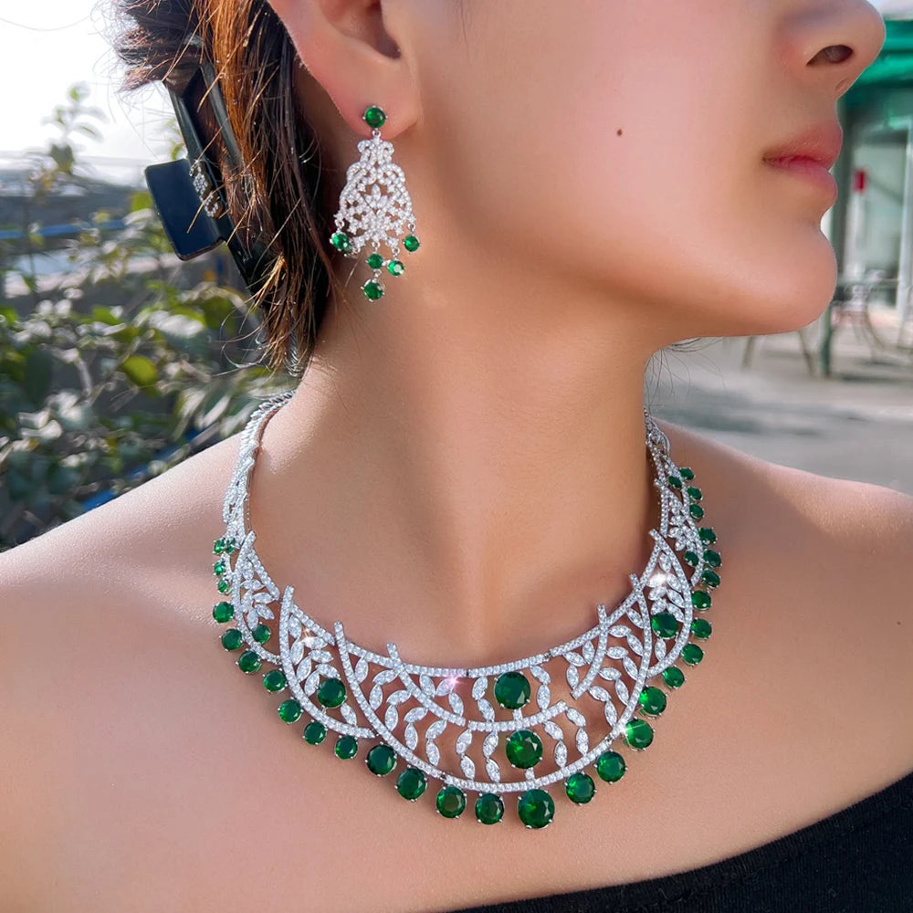 Side view of silver-tone choker-style necklace with green stones and drop earrings