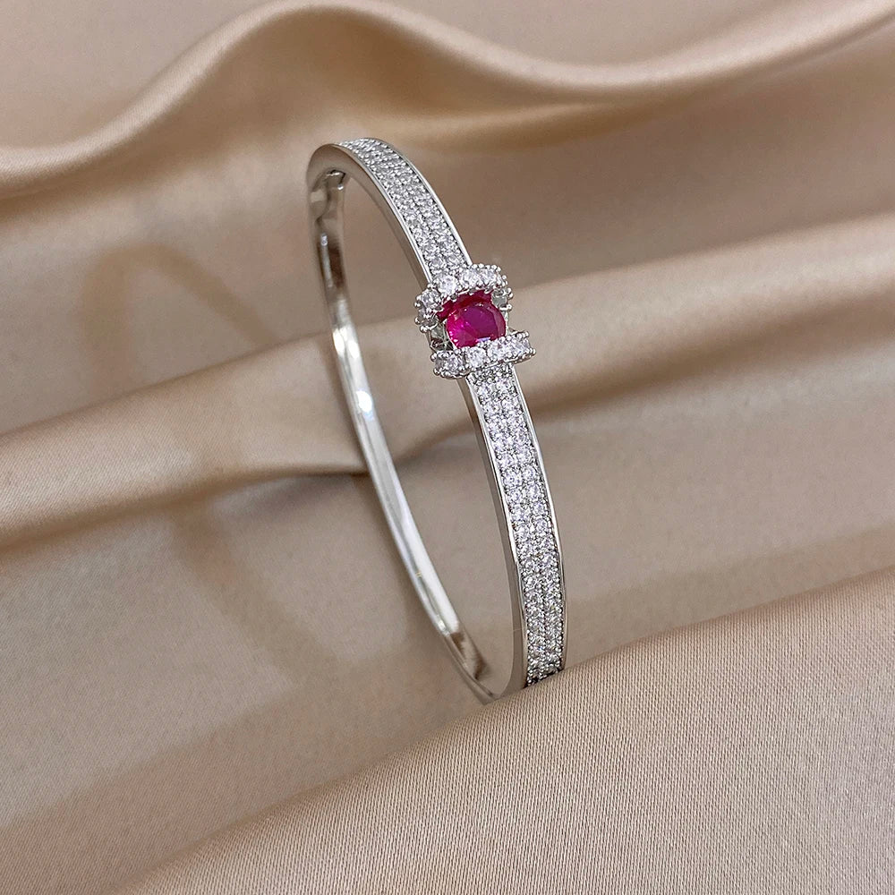 Silver crystal bar cuff bracelet with red round gemstone centerpiece
