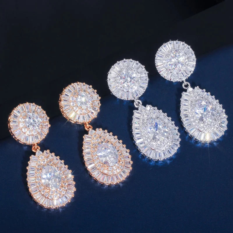 Cubic zirconia earrings set in silver- and rose-gold tones with round halo and teardrop drops