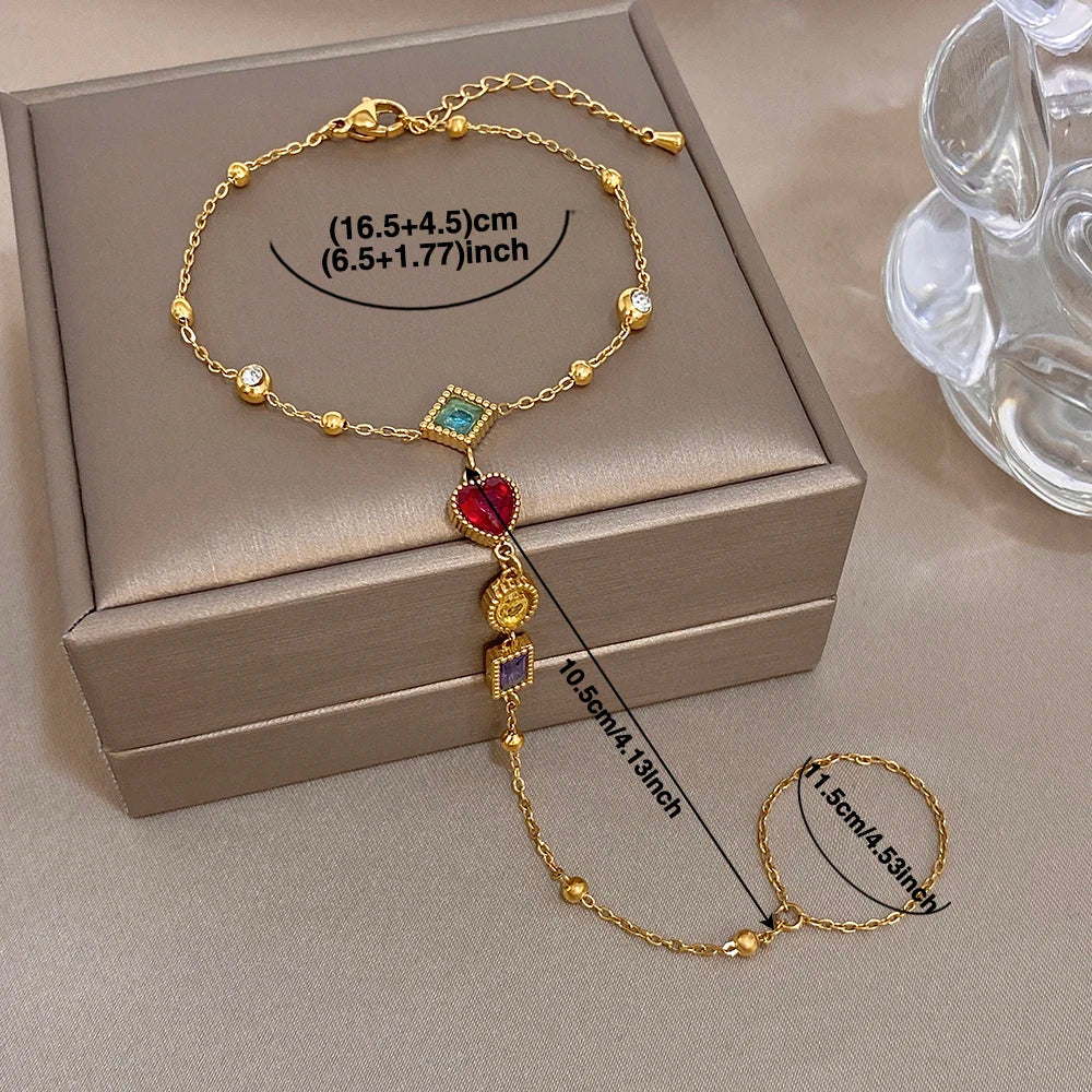 Gold-tone gemstone charm bracelet with multicolor heart and square dangling stones