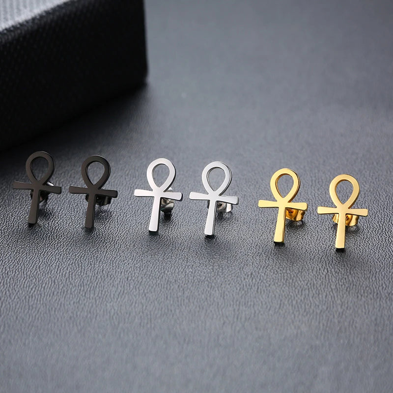 Ankh cross stud earrings in mixed black, silver, and gold on display tray