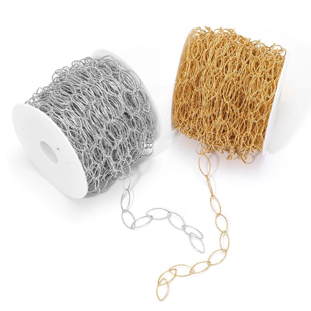 Gold and silver hollow oval link chain strands laid out from spools