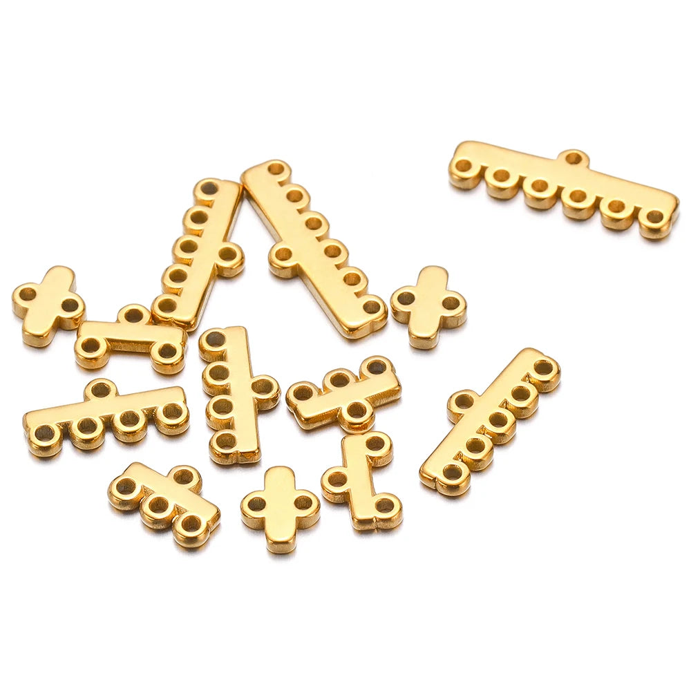 Gold-toned multilayer clasp bail connectors in bar and cross shapes, scattered set