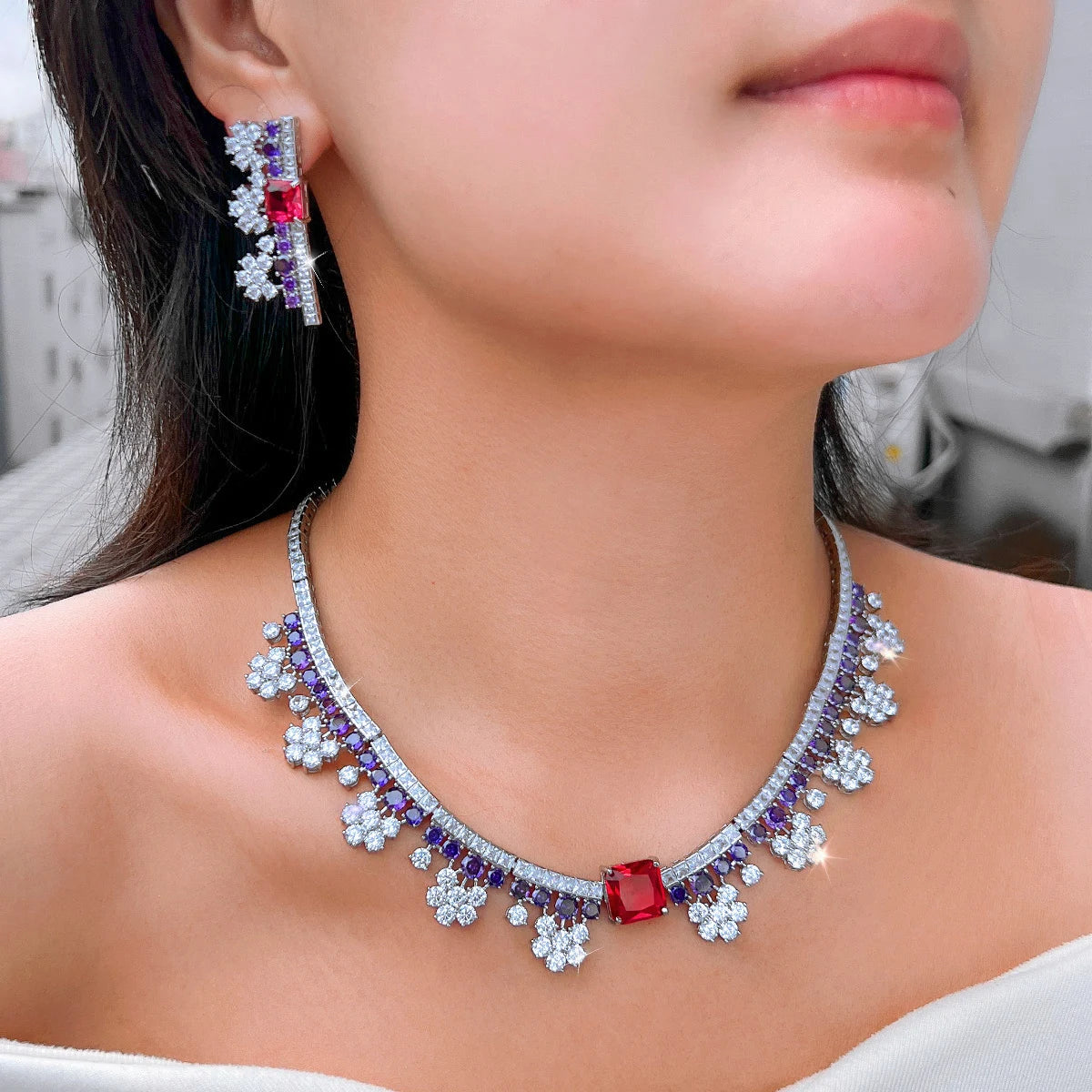 Multicolor crystal choker necklace with red center stone and purple sparkle; matching earrings