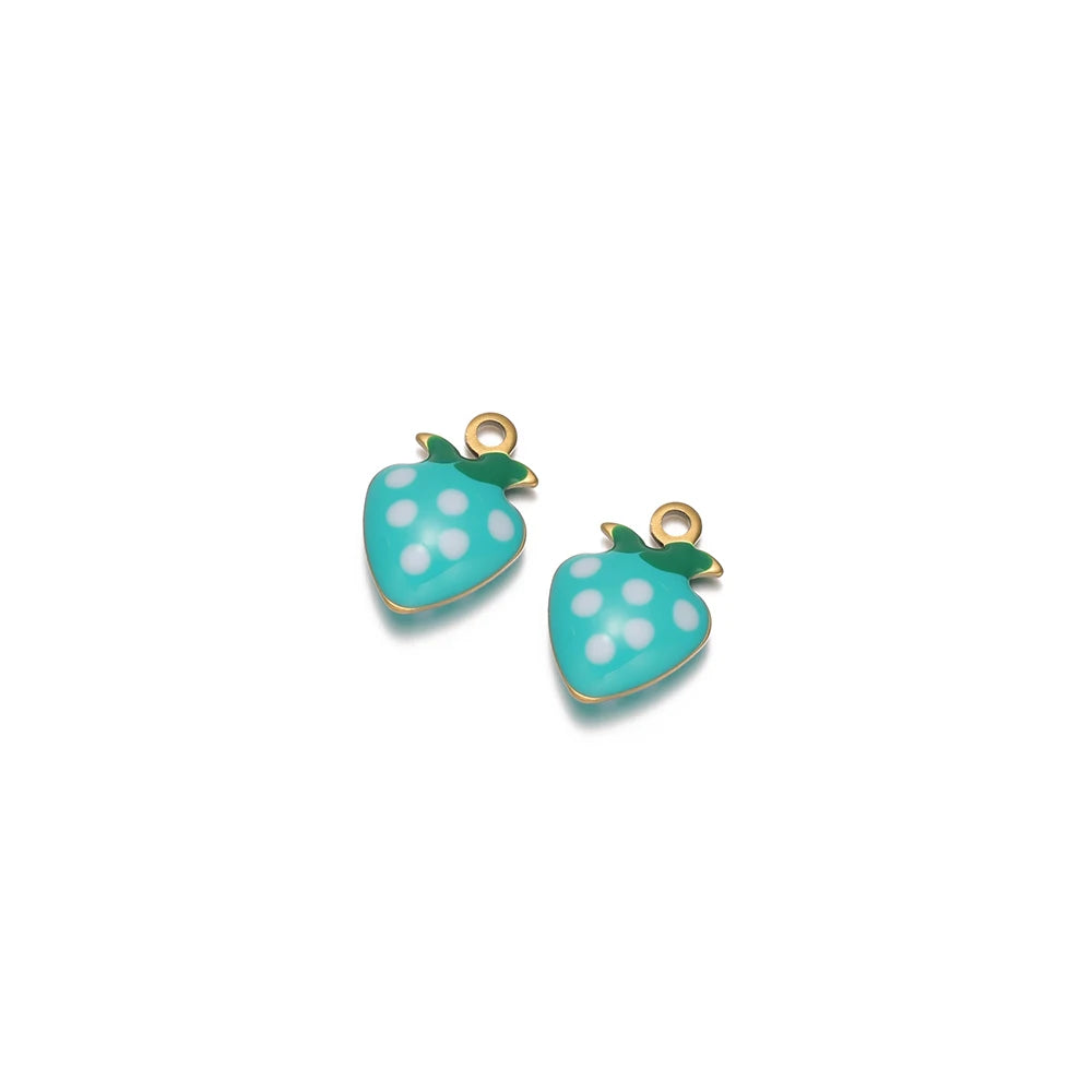 Two teal strawberry charms with white polka dots, green leaf tops, and gold-tone loops