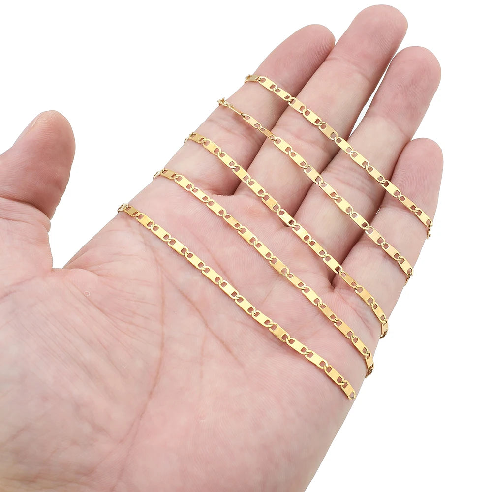 Gold flat link chain multiple strands shown in hand for jewelry making
