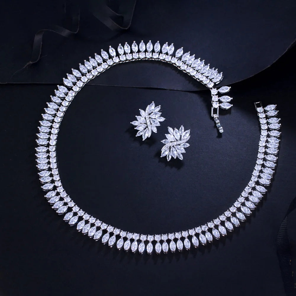 Leaf-shaped cubic zirconia necklace with clasp visible and matching floral stud earrings