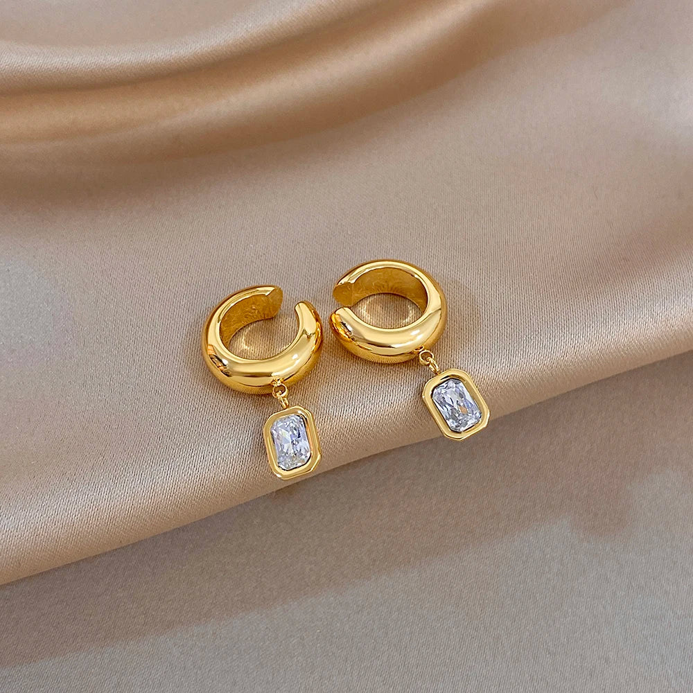 Gold-tone hoop ear clip earrings with two square zirconia drop charms