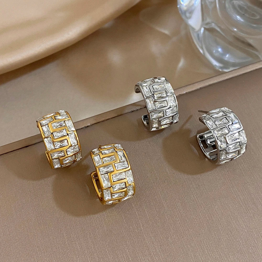 Gold and silver geometric hoop earrings with clear stones, shown from the side