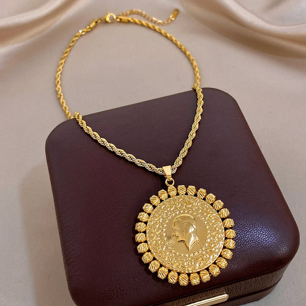 Gold plated pendant necklace with round coin medallion and textured petal border