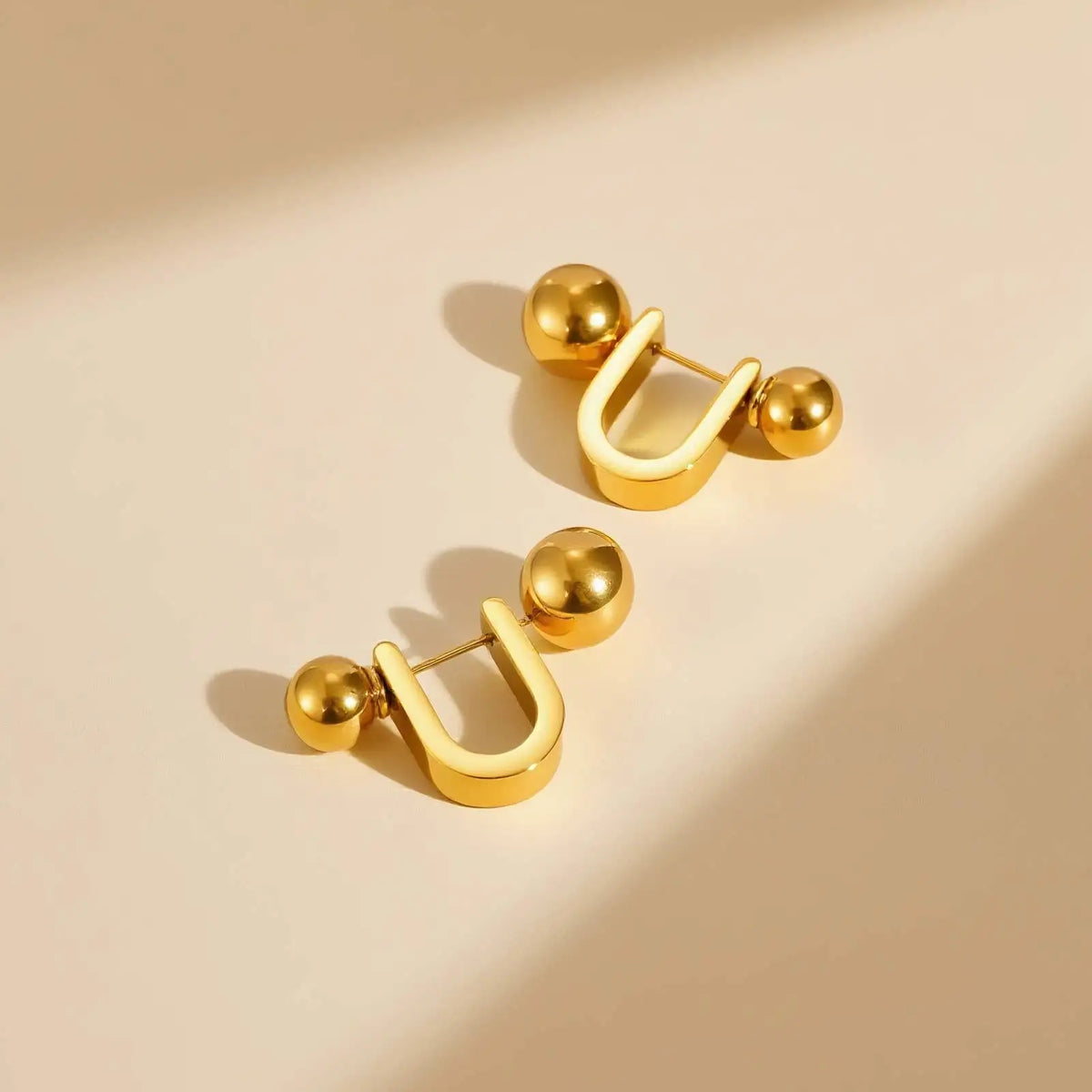 Pair of gold U-shaped hoop earrings with spherical ends