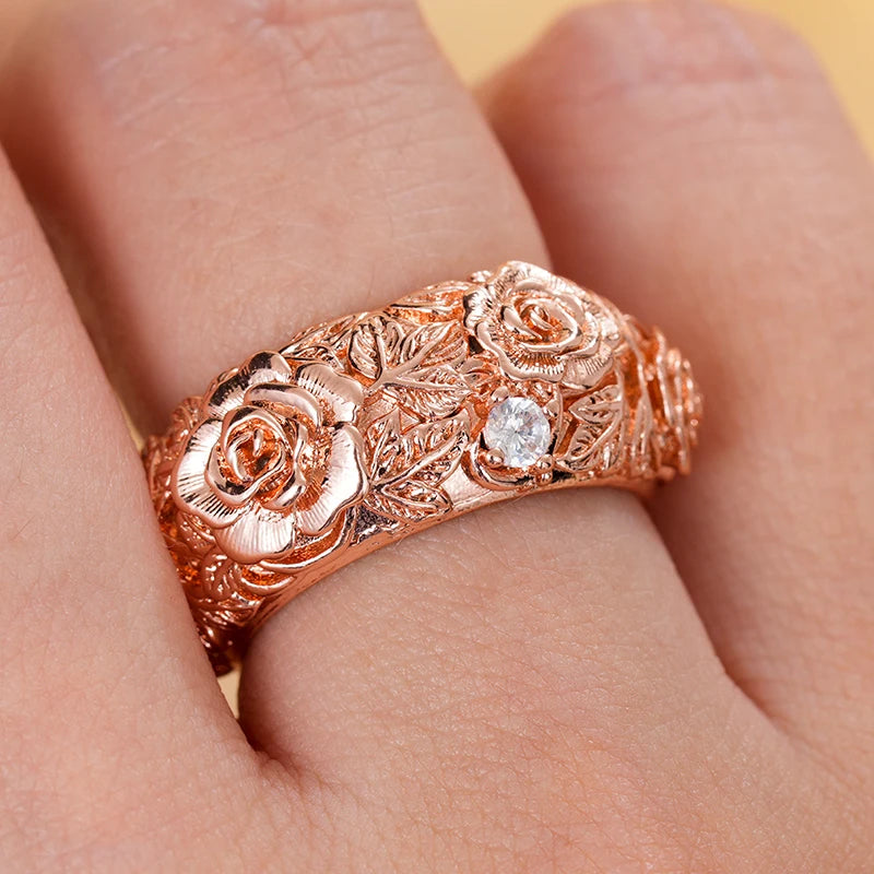 Rose gold floral CZ ring on hand, close-up of rose centerpiece and stones