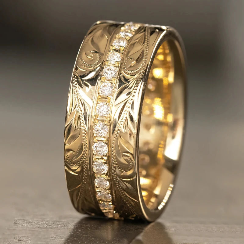 Gold carved wedding band ring with leaf engraving and clear channel-set stones on side