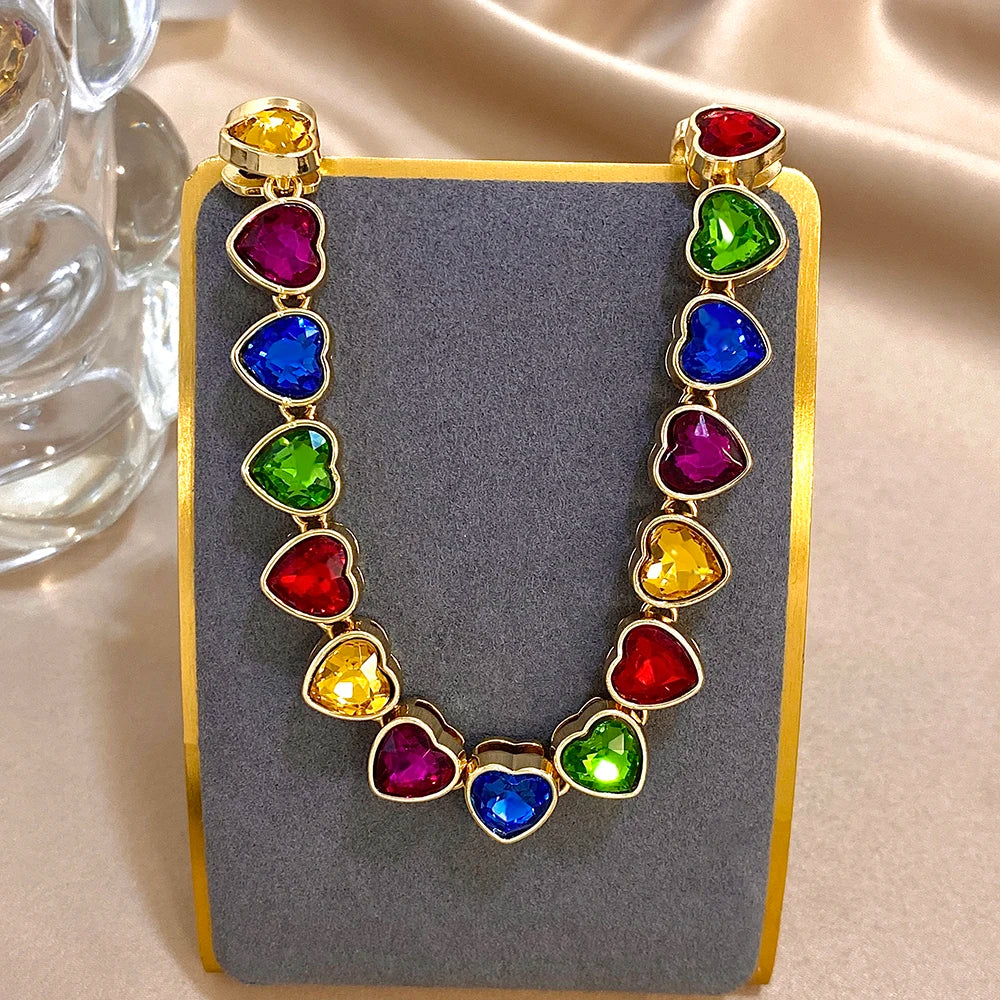 Gold-tone heart zircon link chain choker with multicolor heart stones on display