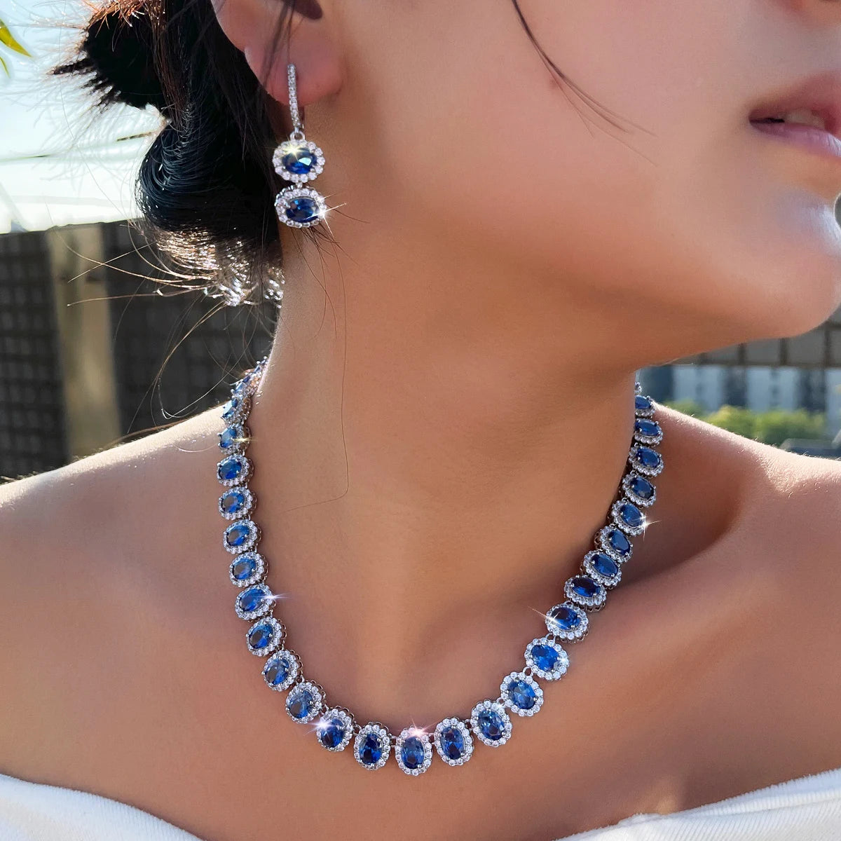 Royal blue cubic zirconia jewelry set with drop hoop earrings and matching necklace