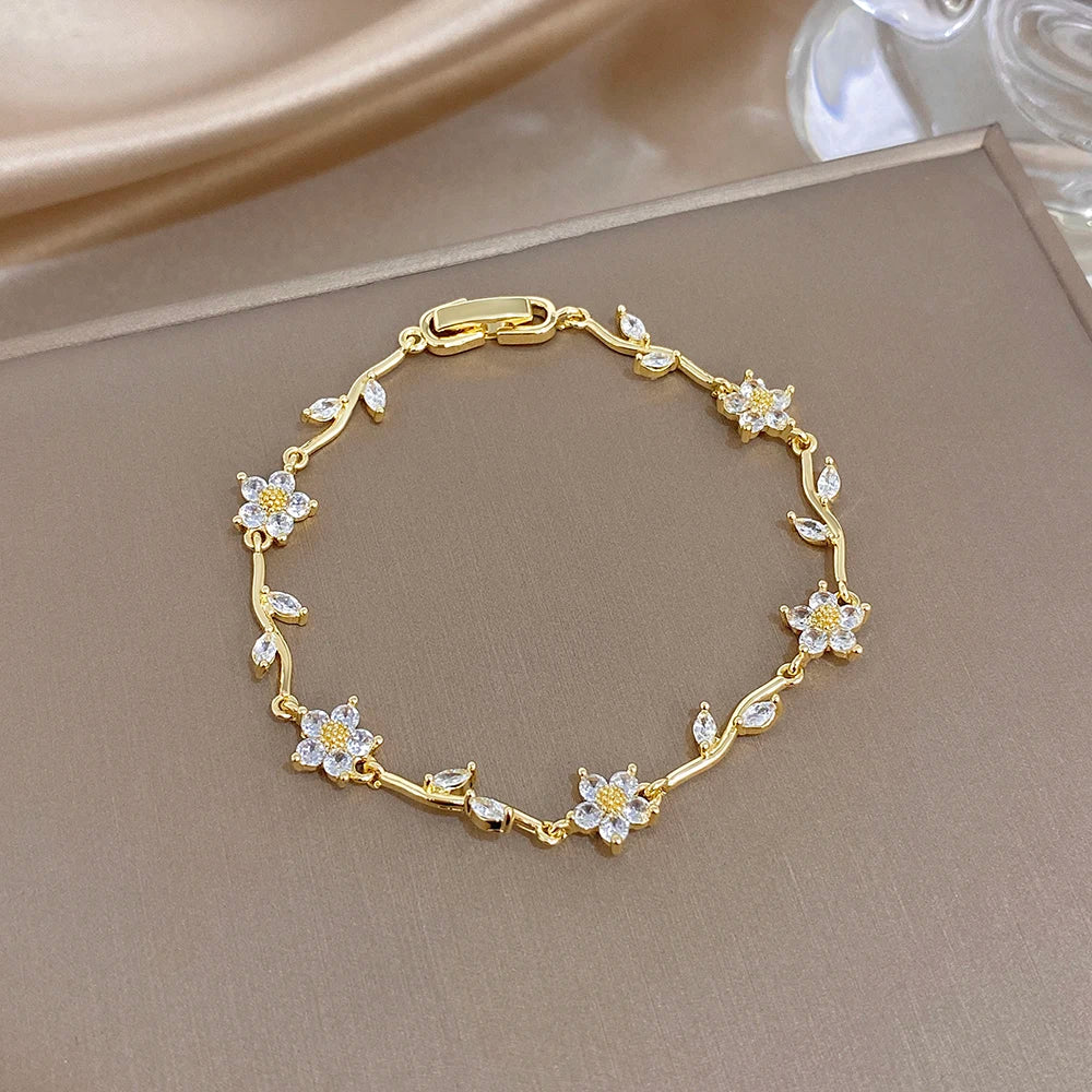 Gold-plated bracelet with clover flower charms and small multicolor zircon accents