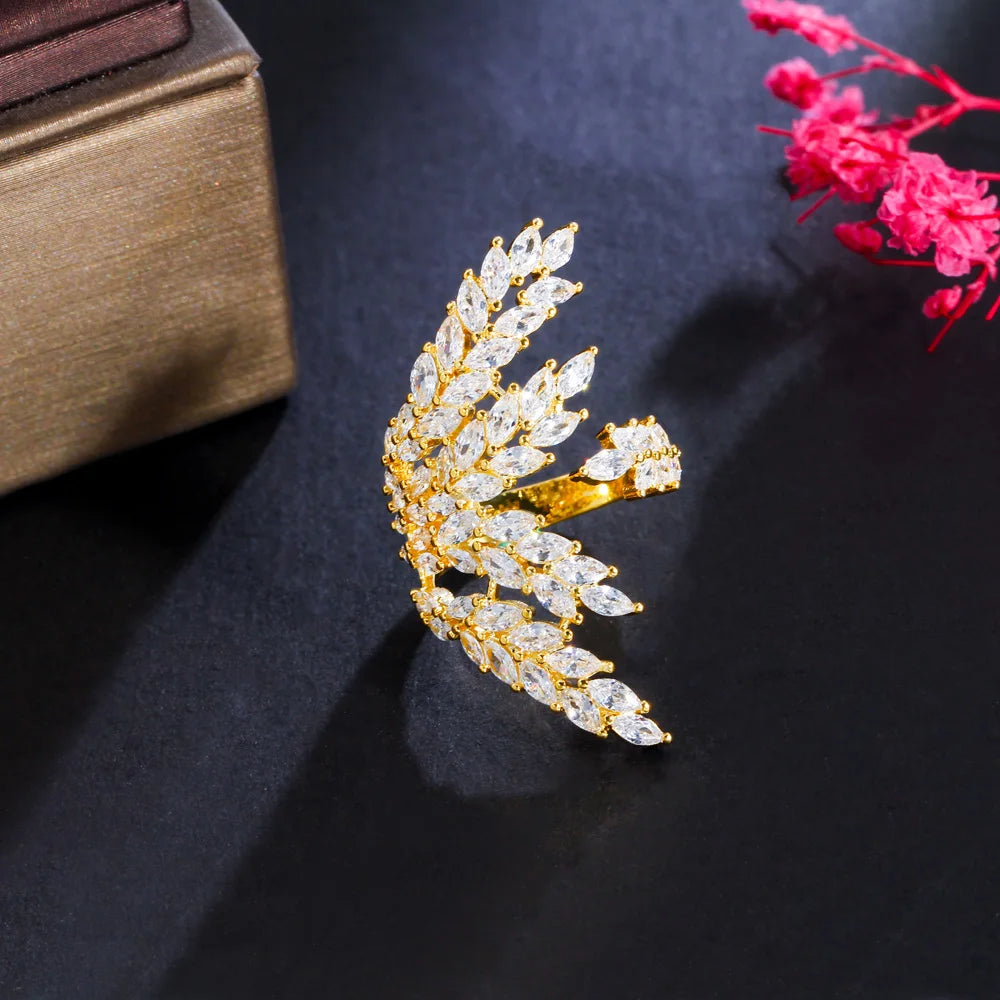 Gold-tone open ring with clear stones arranged in a sweeping leaf pattern