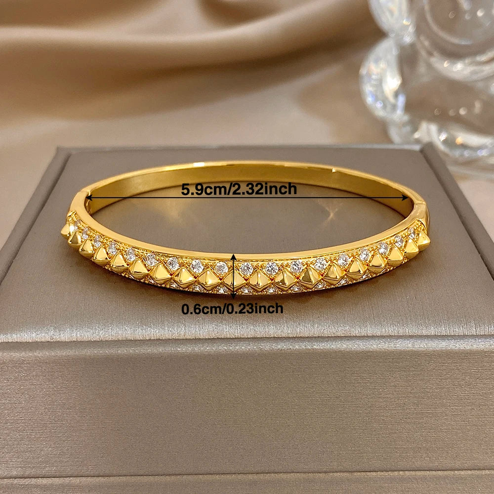 Gold-plated geometric zirconia rivet cuff bangle on gift box, stone band detail