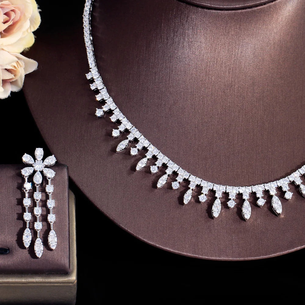 Sparkling cubic zirconia necklace with dangling earrings, silver-tone on display bust