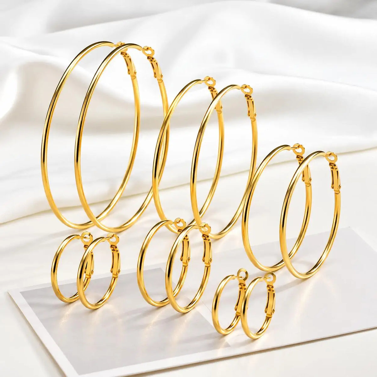 Gold-tone stainless steel hoop earrings in six sizes, from small to oversized.