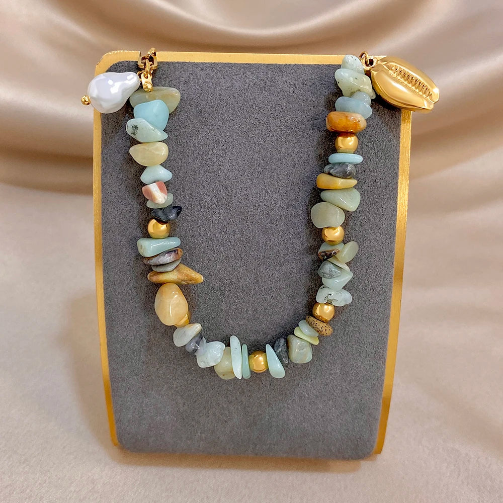 Chunky beaded bracelet with gold clasp, pale blue and cream stones, small seashell pearl accents