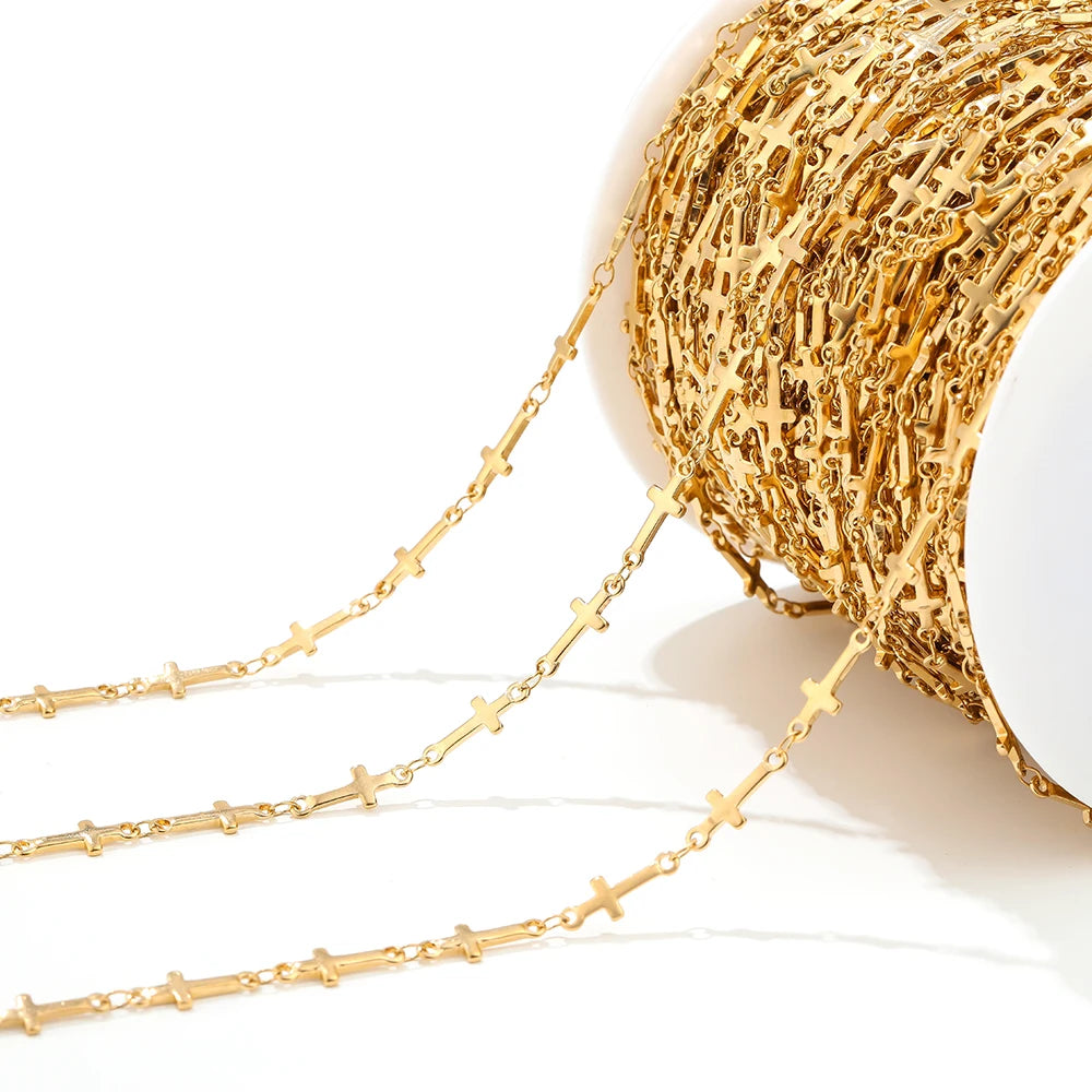 Gold cross chain strands laid out, repeating small cross pendant connectors
