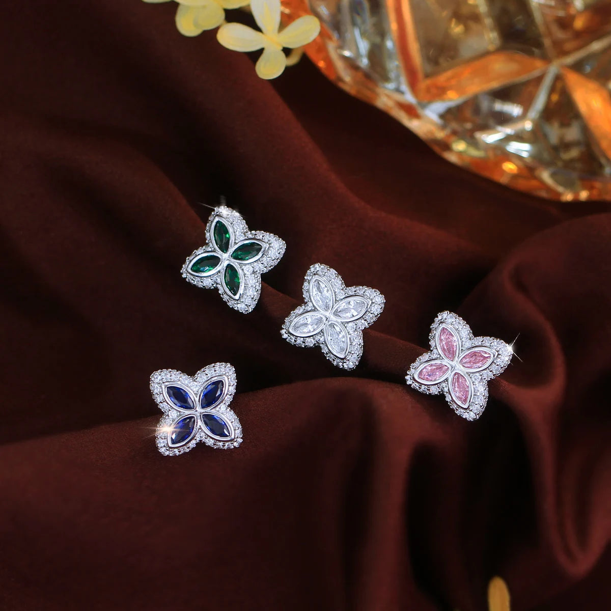Four-leaf stud earrings with green, clear, pink and blue stones