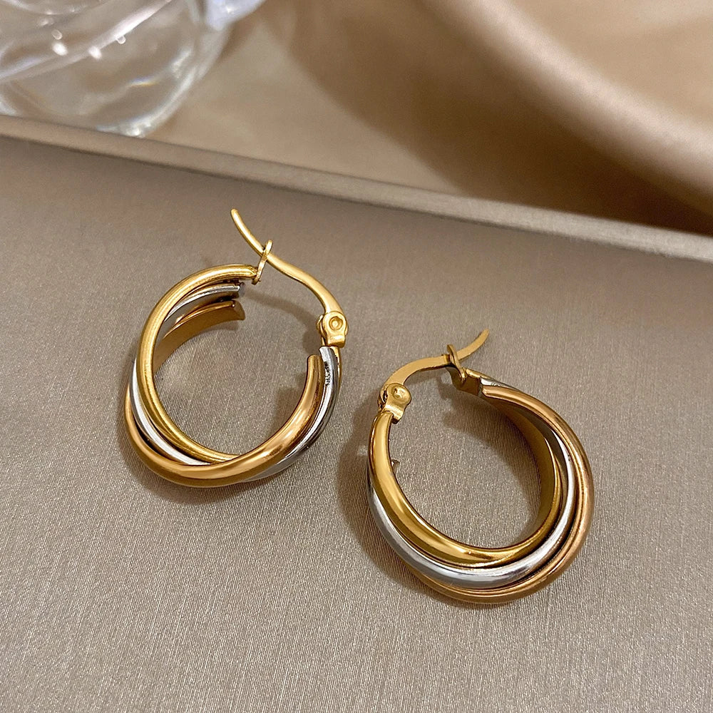 Gold and silver twisted hoop earrings viewed from above