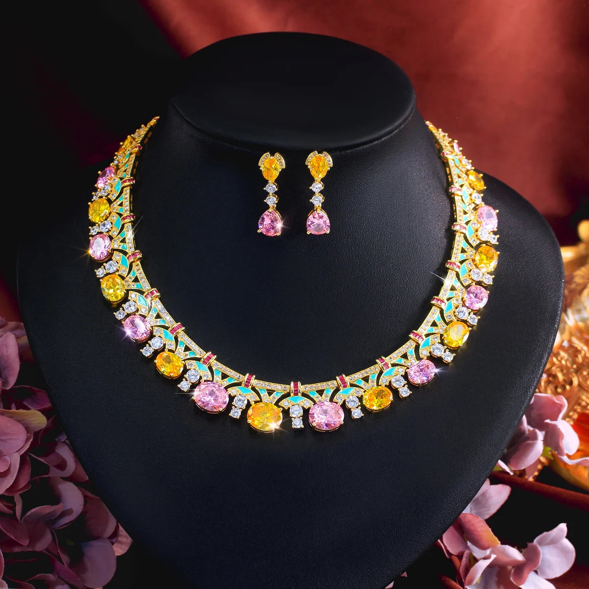 Gold-tone multicolor cubic zirconia necklace and drop earrings set on black display stand