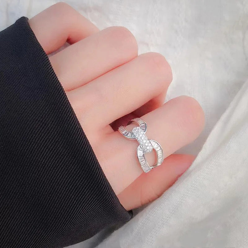 Silver-tone linked wedding ring on a woman's finger