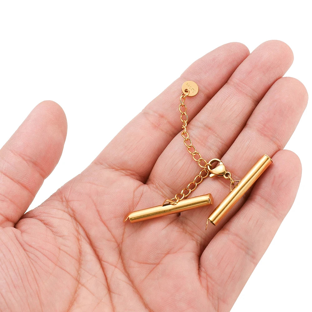 Gold crimp end caps on chain with slider clasp connectors held in hand