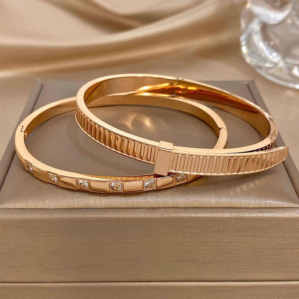 Rose gold cuff bangles with ribbed geometric panel and clear stone rows
