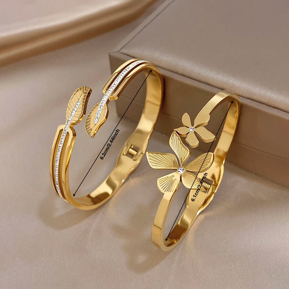 Gold plated stainless steel cuff bangles with leaf and flower zircon accents
