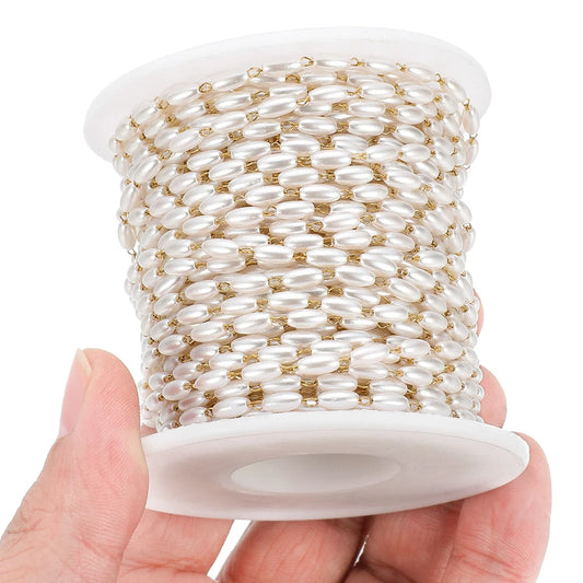Pearl bead chain on a spool with white oval beads and gold-tone metal links