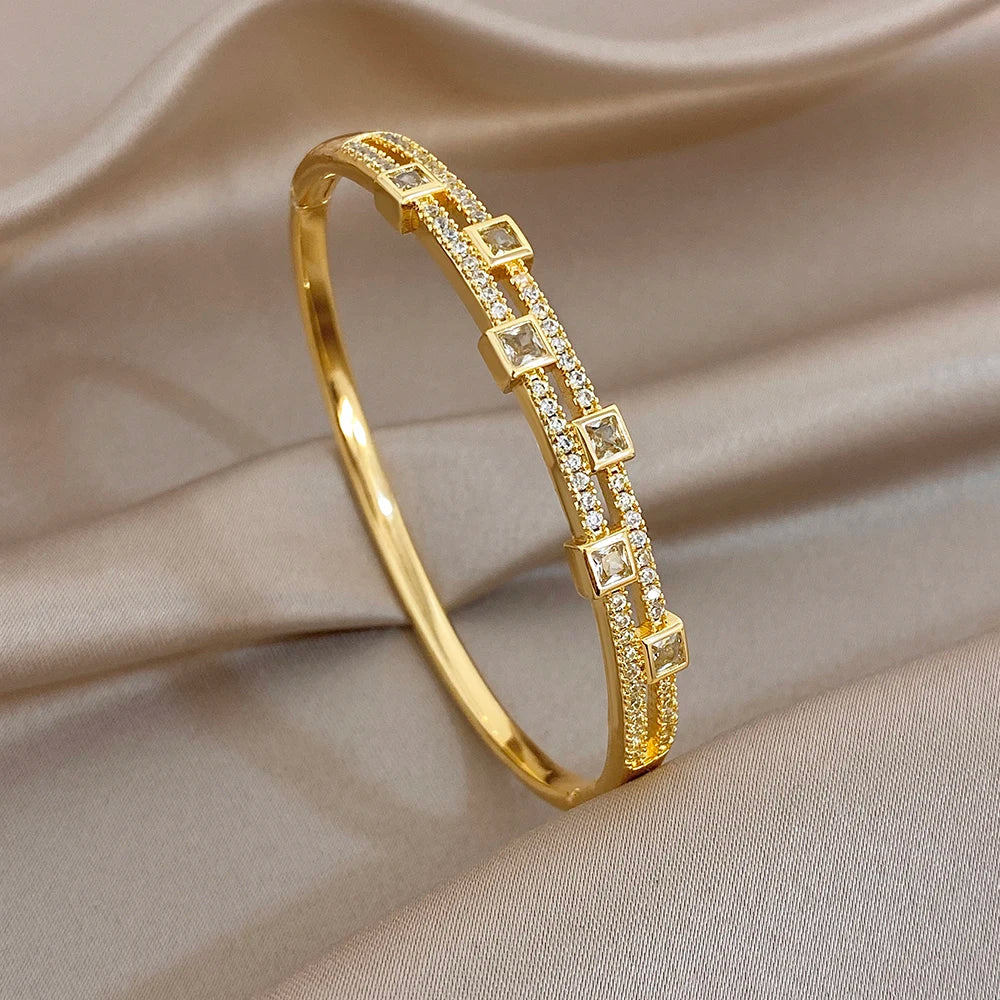 Gold-tone rhinestone bangle bracelet with square link bezels, close side view