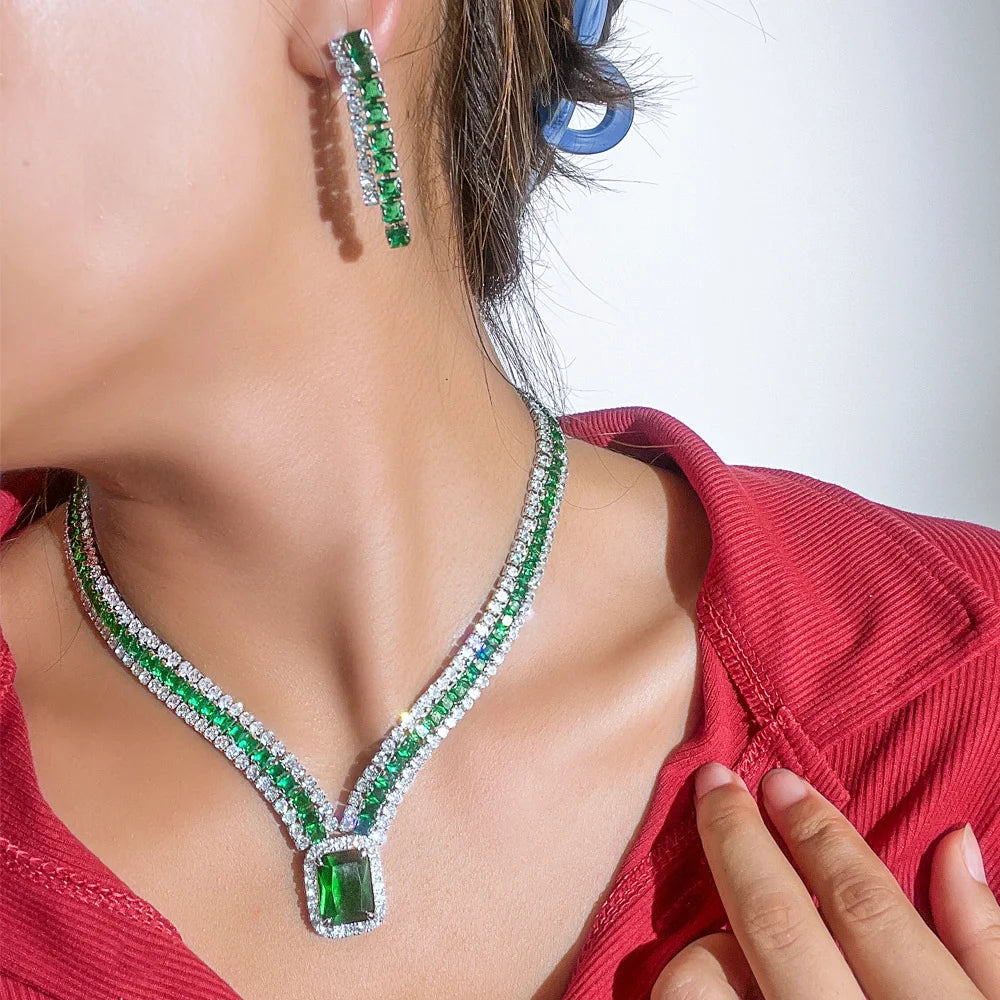 Green cubic zirconia rectangle pendant necklace and drop earrings worn close-up