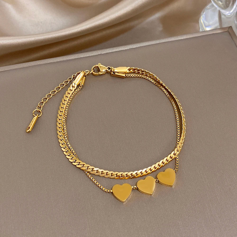 Gold-tone slim chain bracelet with heart charms and braided double chain