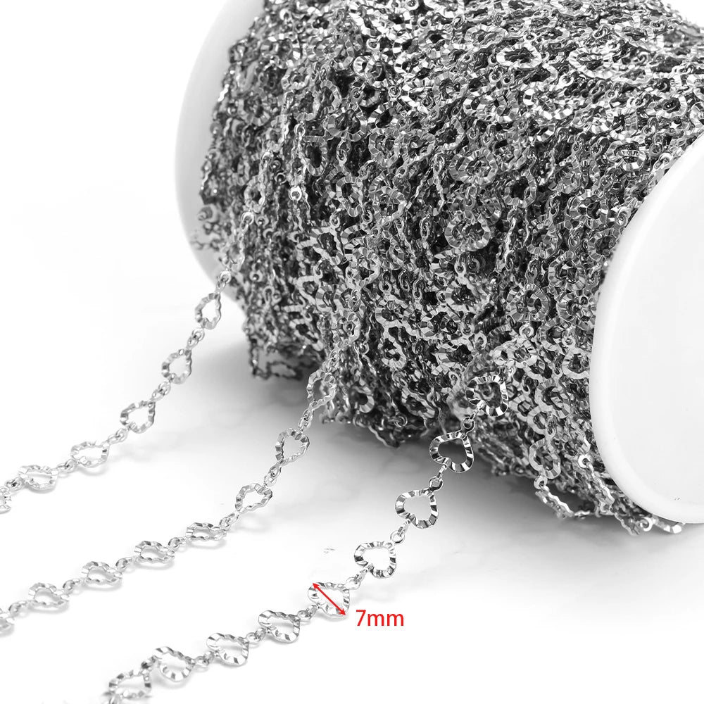 Silver hollow chain with loop links, 7mm width shown, on a white spool