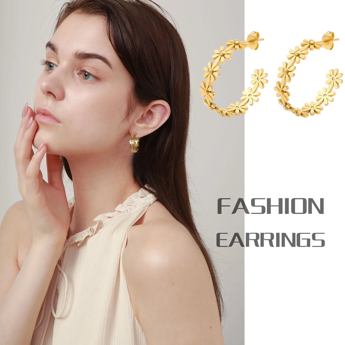 Gold-tone daisy flower hoop earrings worn by model, showing front flower charm pattern