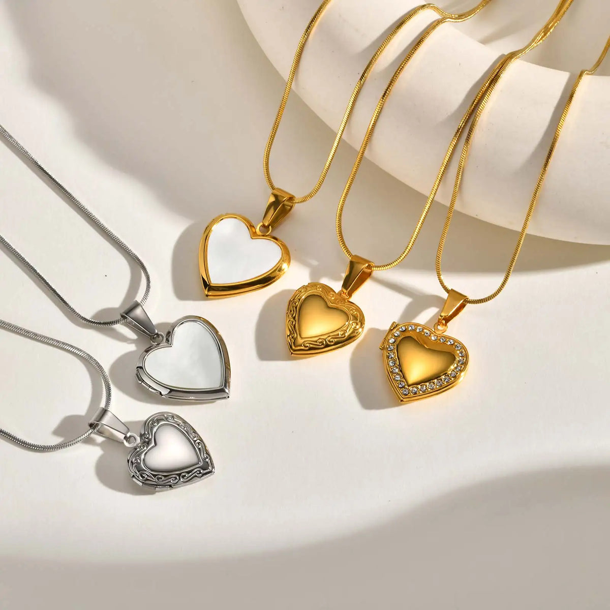 Heart pendant necklace set with gold and silver heart charms on thin chains