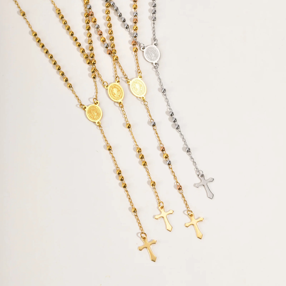 Gold- and silver-tone rosary necklaces with Virgin Mary coin charms and cross pendants