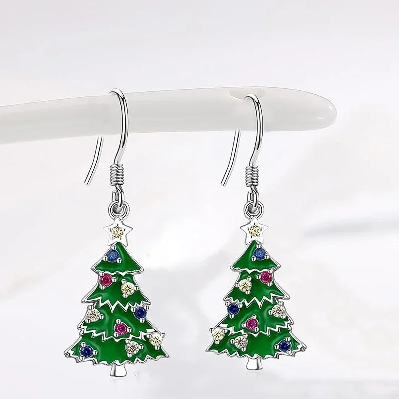 Pair of Christmas tree drop earrings with green enamel, star topper, and colorful gem accents