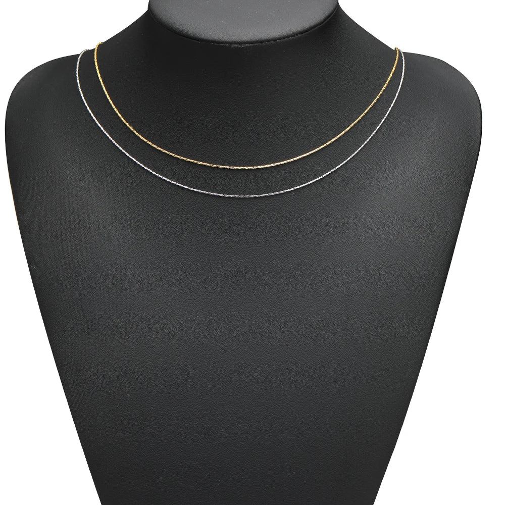 Thin wire necklace chains on black mannequin, gold and silver tones