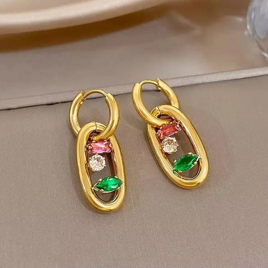 Gold hoop earrings with oval multicolor gem drop settings in red, green, and clear stones