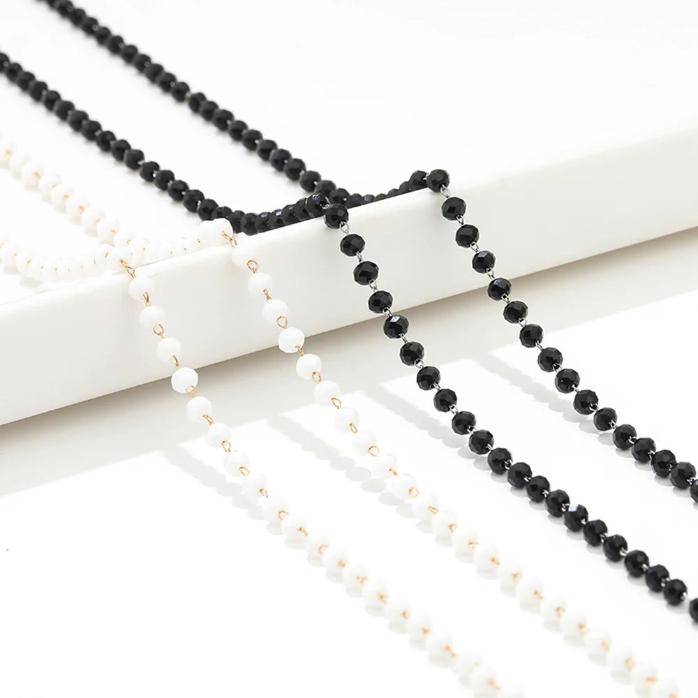 Two beaded necklace chains with black and white pearl-like beads