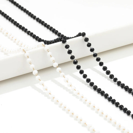 Two beaded necklace chains with black and white pearl-like beads